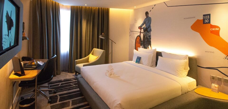 Modern hotel room interior in South Jakarta, offering cozy ambiance with warm lighting and stylish decor.