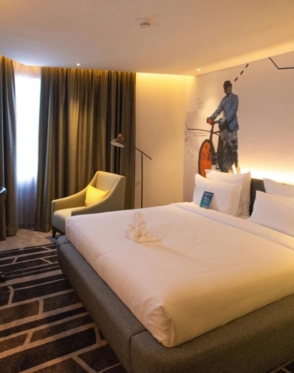 Modern hotel room interior in South Jakarta, offering cozy ambiance with warm lighting and stylish decor.