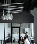 Business professionals engaged in a collaborative meeting in a stylish, modern office setting.