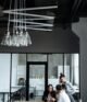 Business professionals engaged in a collaborative meeting in a stylish, modern office setting.