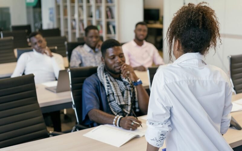A group of professionals engaging in a training session in a modern office setting.